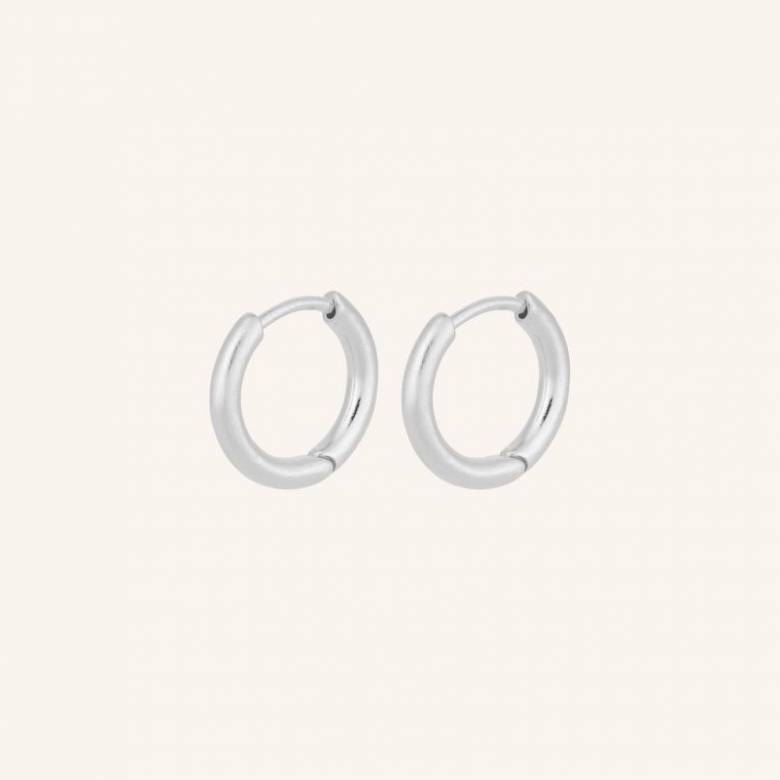 Solid Huggies Hoop Earrings In Silver By Pernillle Corydon